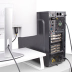 Computer tower on a white desk with a monitor in the background