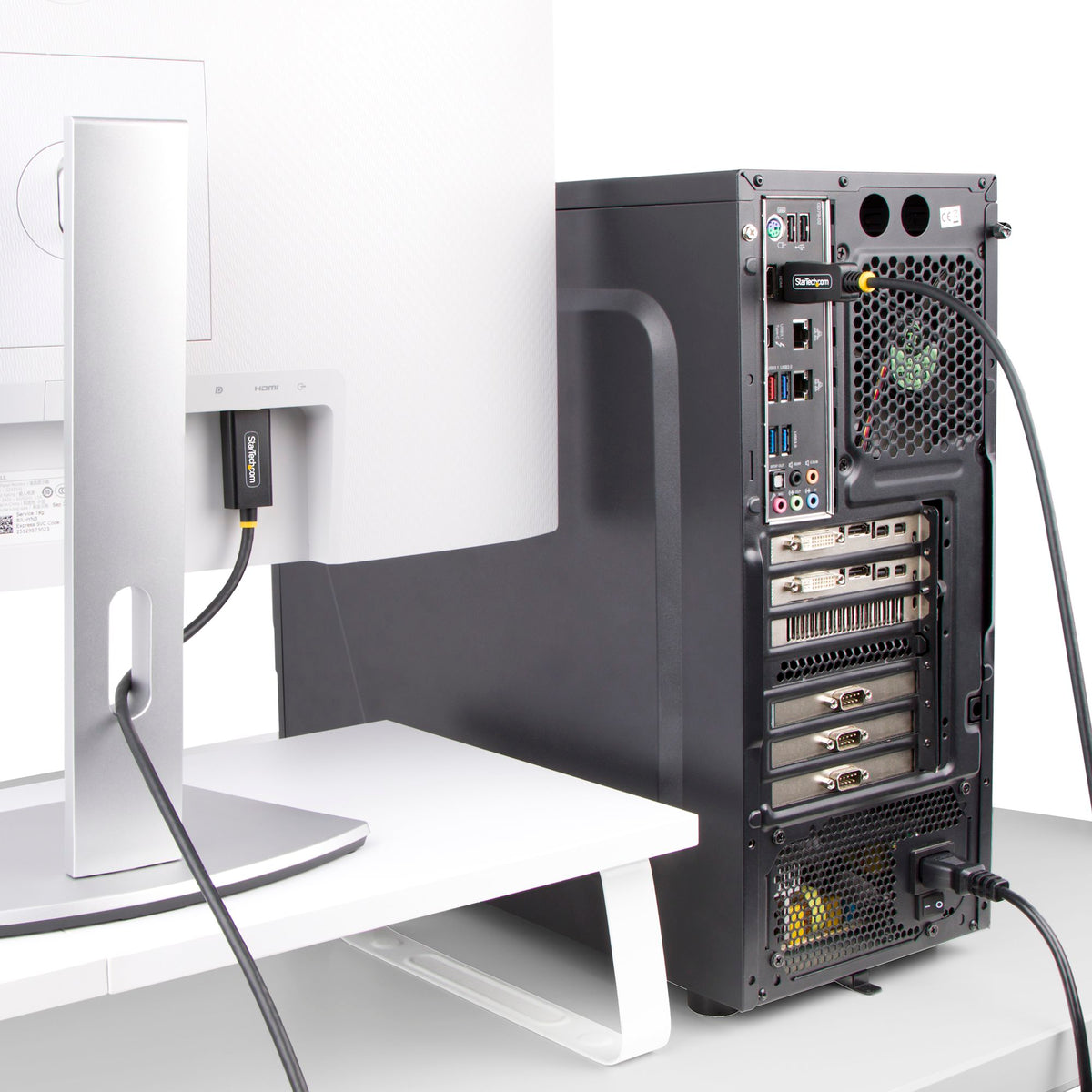 Computer tower on a white desk with a monitor in the background