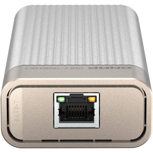 A silver and beige rectangular electronic device with a ribbed top surface and a front RJ45 Ethernet port, shown on a plain white background.