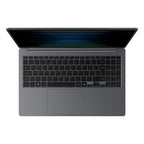 A top-down view of a dark gray laptop with the screen open, featuring a black keyboard and a large touchpad on a solid white background.