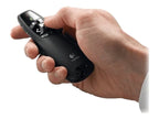 Hand holding a black Logitech device on a white background