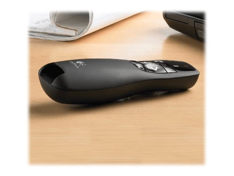 Black Logitech remote control on a wooden surface