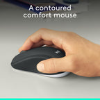 Hand holding a Logitech contoured comfort mouse on a neutral background