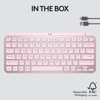 Pink keyboard with USB cable on a light gray background