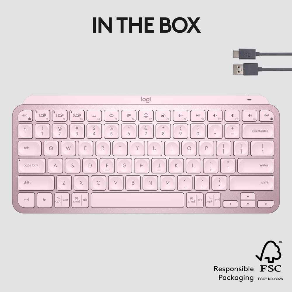 Pink keyboard with USB cable on a light gray background