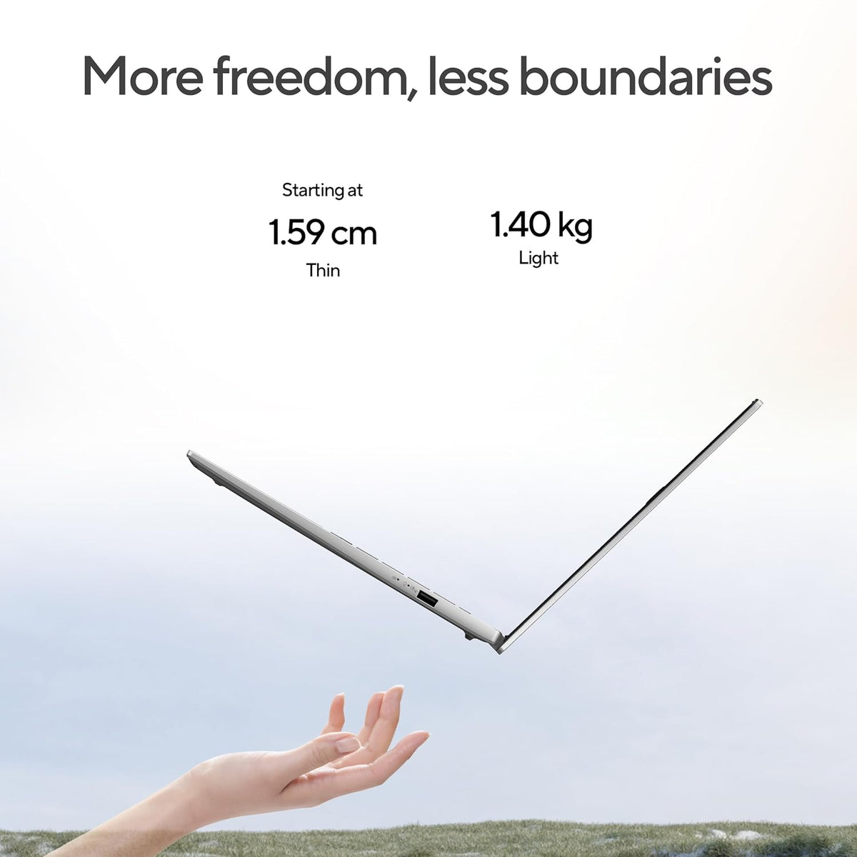 A thin silver laptop is shown floating in midair above an outstretched hand, with marketing text at the top reading 'More freedom, less boundaries' and additional specs 'Starting at 1.59 cm Thin' and '1.