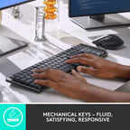 Person typing on a mechanical keyboard with a blurred office background
