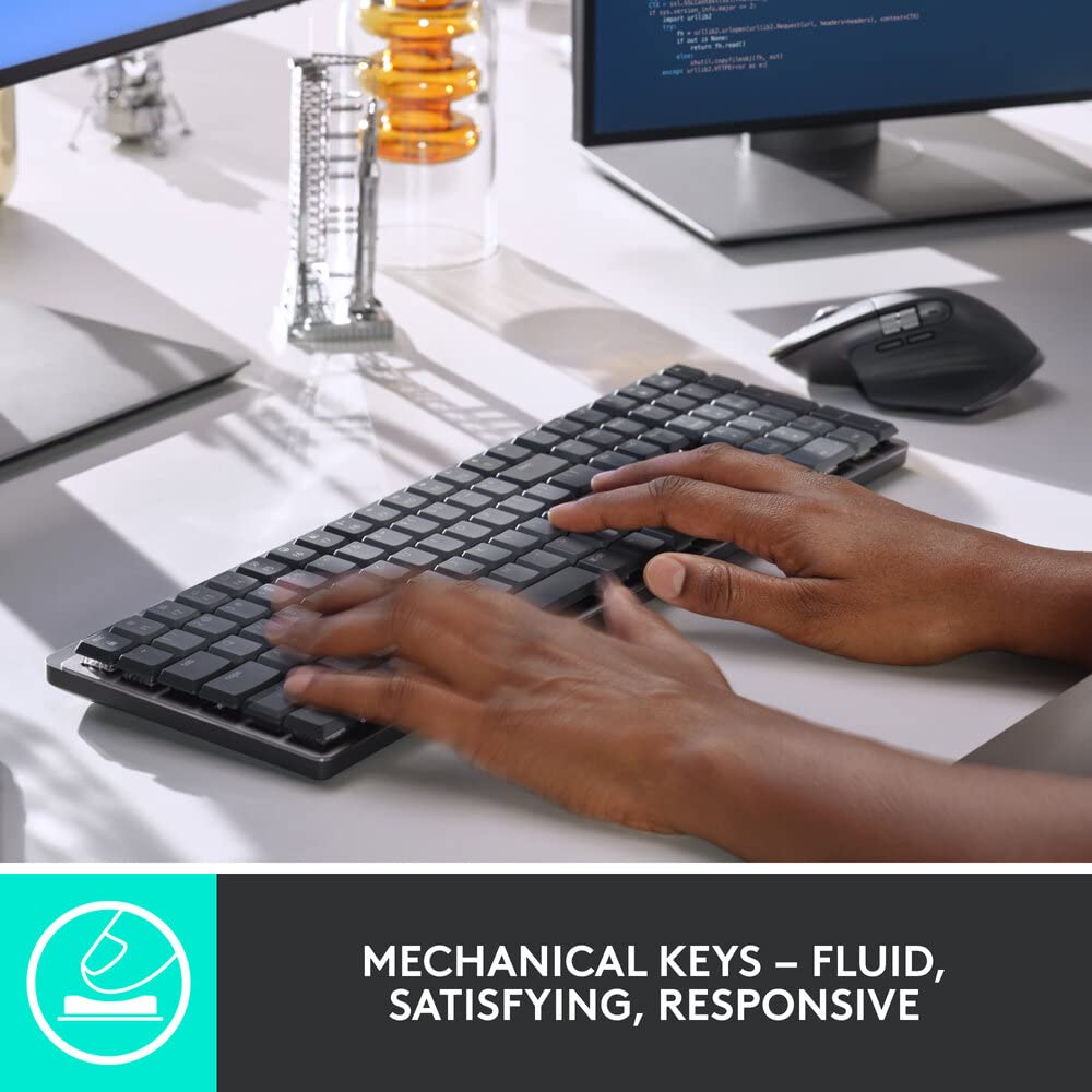 Person typing on a mechanical keyboard with a blurred office background