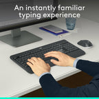 Person typing on a keyboard with a monitor, mouse, and cup in the background.