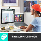 Person using a computer with a focus on comfort, sitting at a desk with multiple screens.