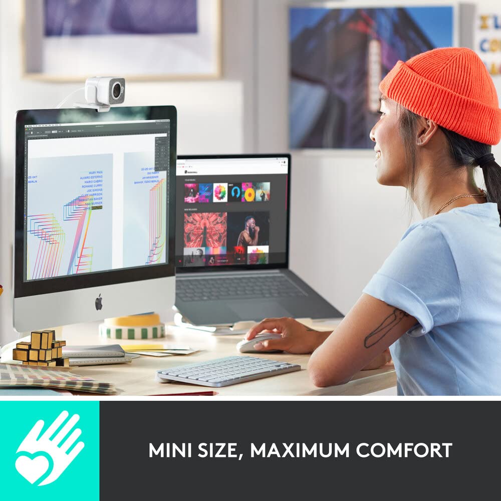 Person using a computer with a focus on comfort, sitting at a desk with multiple screens.