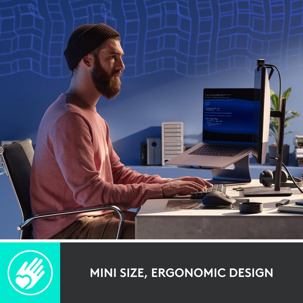 Man using a computer with a mini size, ergonomic design feature highlighted.