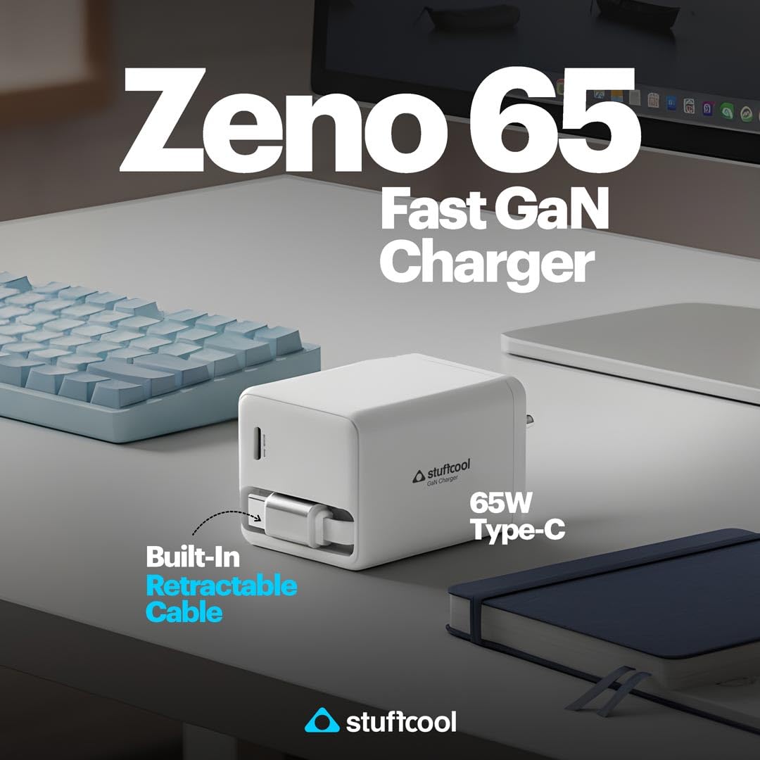 A white Stuffcool Zeno 65 Fast GaN Charger with a built-in retractable cable, shown on a desk next to a keyboard, laptop, and notebook. The image features promotional text overlays.