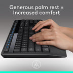 Black keyboard with a hand on it, emphasizing a generous palm rest for comfort.