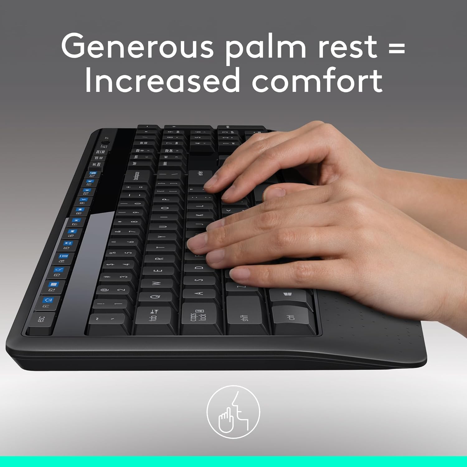 Black keyboard with a hand on it, emphasizing a generous palm rest for comfort.
