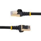 StarTech C6ASPAT10BK 10ft Cat6a Shielded Ethernet Cable in black, coiled on a surface