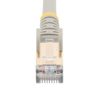 StarTech C6ASPAT10GR 10ft Cat6a Shielded Ethernet Cable grey cable coiled on a desk