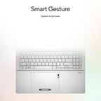 A silver laptop shown from the front with a blurred keyboard and trackpad, under the text 'Smart Gesture' and 'System brightness' on a soft white-to-light-gray gradient background.
