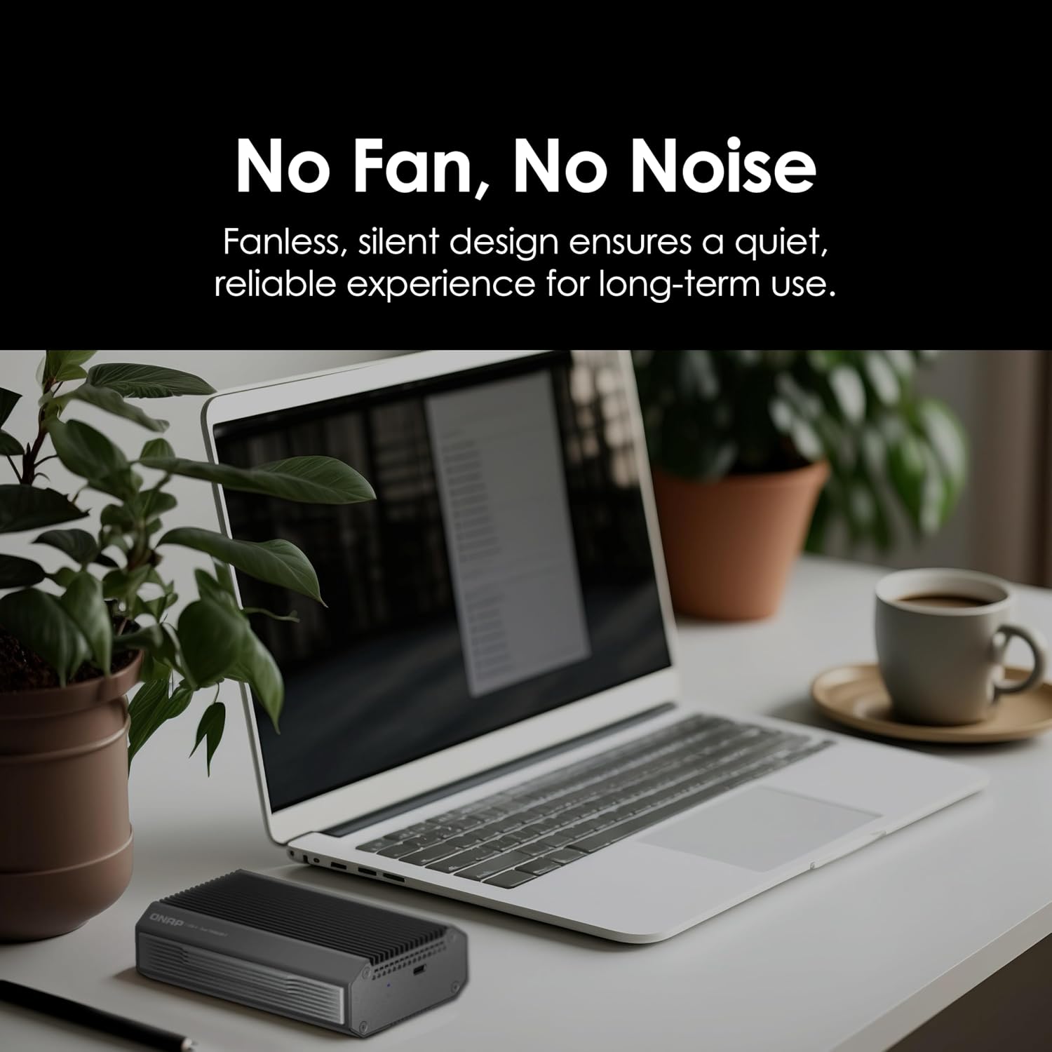 Laptop on a desk with a small device labeled 'No Fan, No Noise' and text about its design.