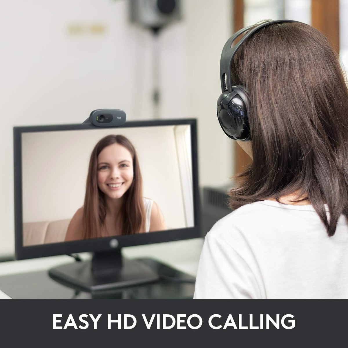 Person using a computer for an HD video call with another person.
