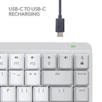 A Logitech USB-C to USB-C charging cable shown above a white keyboard on a light gray background, with the text 'USB-C TO USB-C RECHARGING' at the top left.