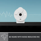A white Logi security camera shown against a light blue background with waveform graphics, plus a dark banner at the bottom reading 'BE HEARD WITH NOISE-REDUCING MIC' and a microphone icon. The product itself is the camera, not the banner or environment.