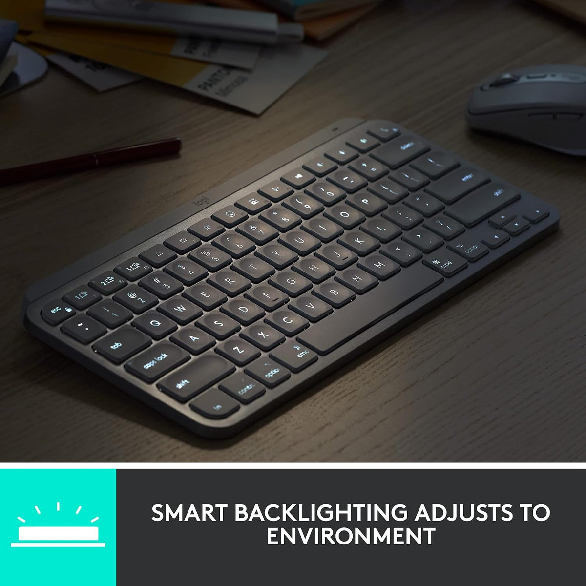 Keyboard with smart backlighting on a desk with a mouse and papers.