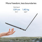A laptop shown open and floating against a pale sky background, with a human hand reaching toward it. Text at the top reads 'More freedom, less boundaries' and 'Starting at 1.