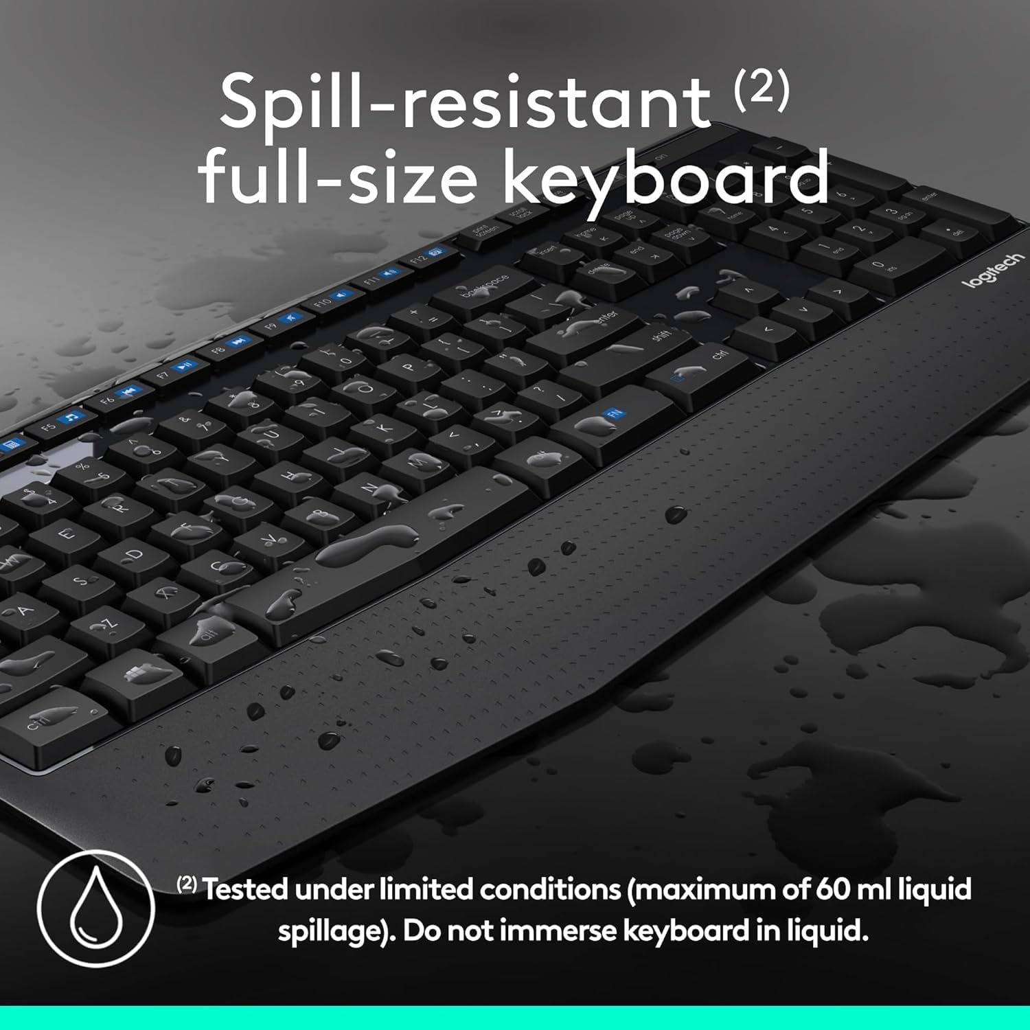 Spill-resistant full-size keyboard with water droplets on a dark background
