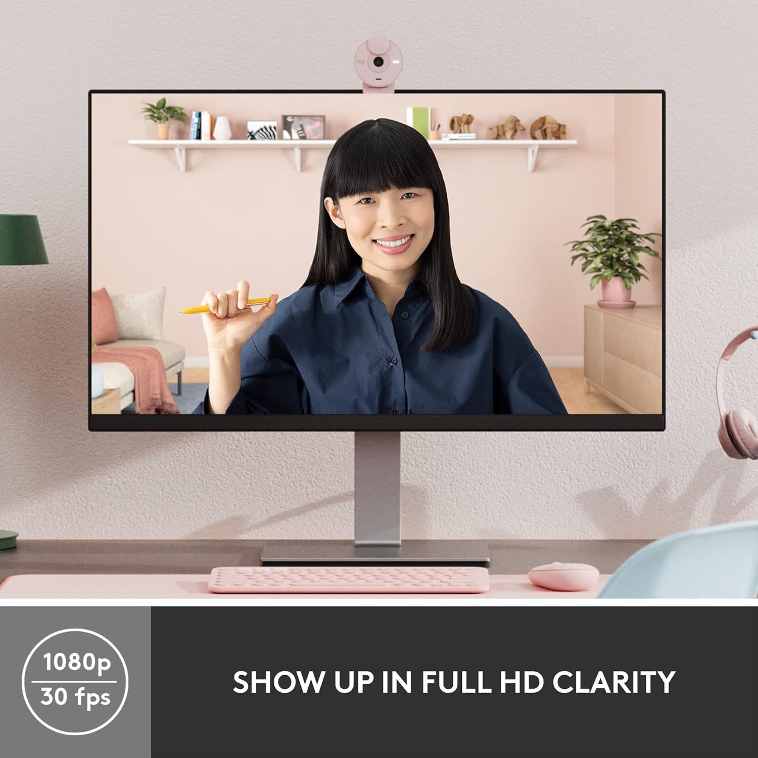 Person using a computer with a webcam on a desk, showing a video call with a woman on the screen.