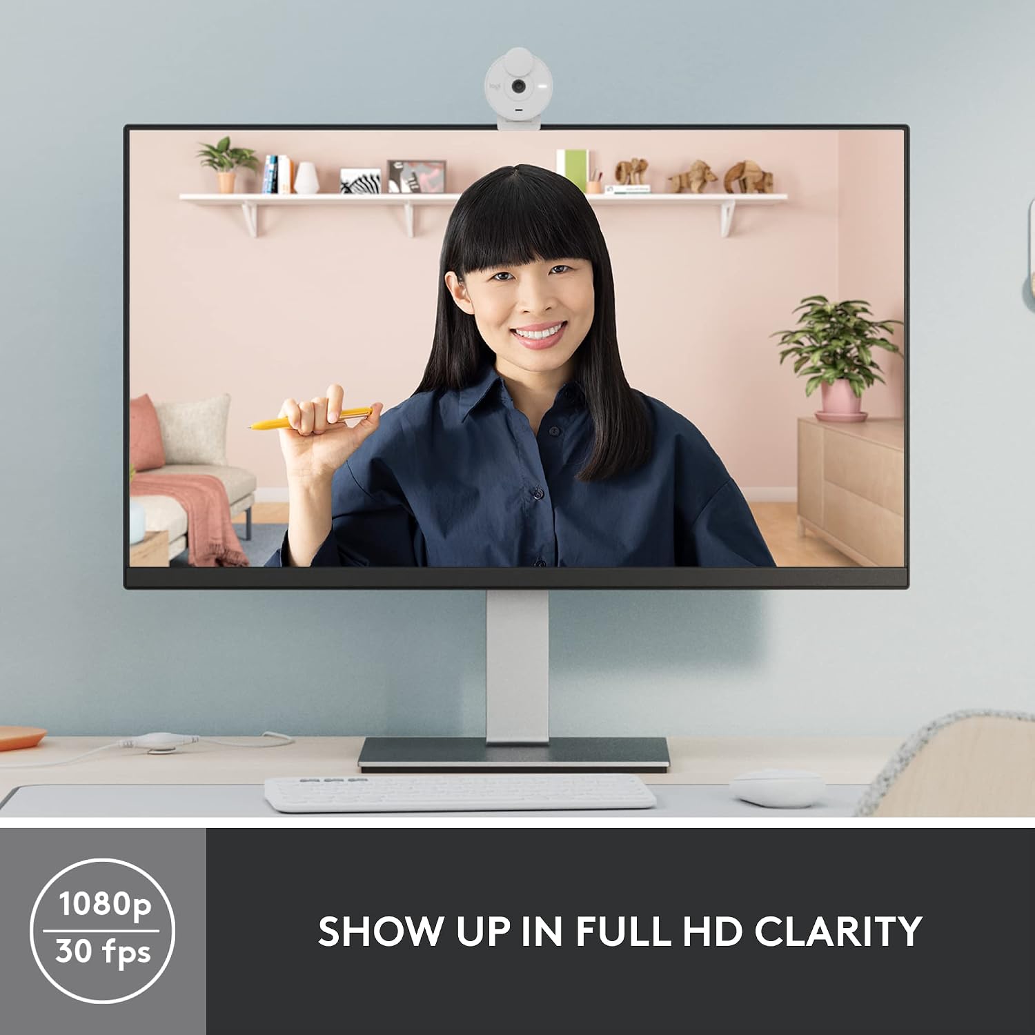 Computer monitor displaying a person in a home office setting with text 'Show up in full HD clarity'.