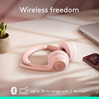 Pink wireless headphones on a soft surface with text 'Wireless freedom' and product details.