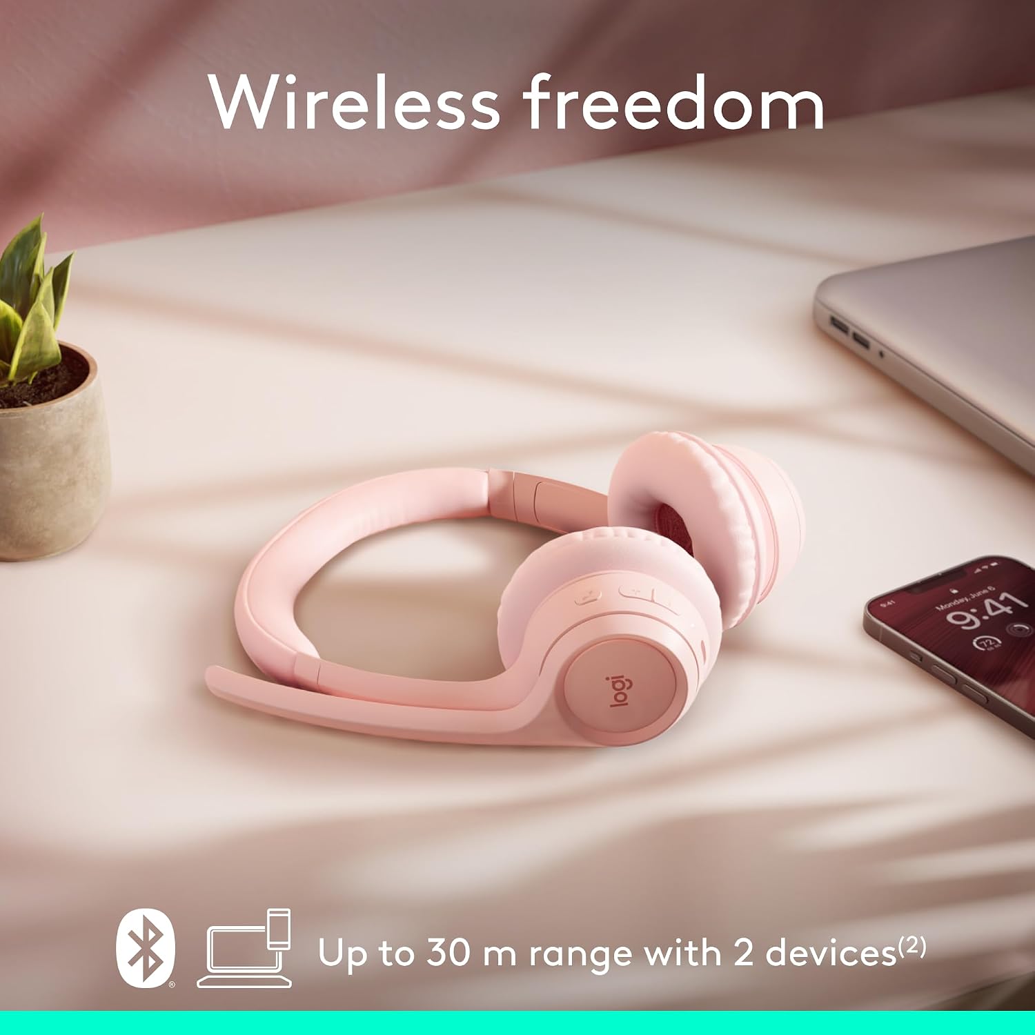 Pink wireless headphones on a soft surface with text 'Wireless freedom' and product details.