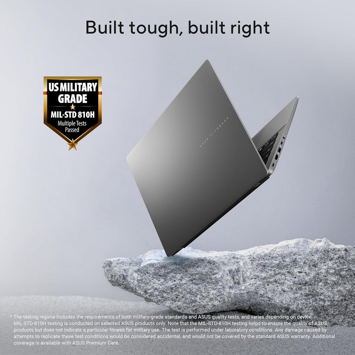 A dark gray ASUS laptop floating above a rock, with the headline 'Built tough, built right' and a 'US Military Grade MIL-STD 810H Passed' badge on a light gray background.