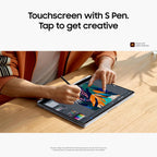 A person seated at a wooden desk using a tablet with an attached stylus pen, with large marketing text at the top reading 'Touchscreen with S Pen. Tap to get creative.