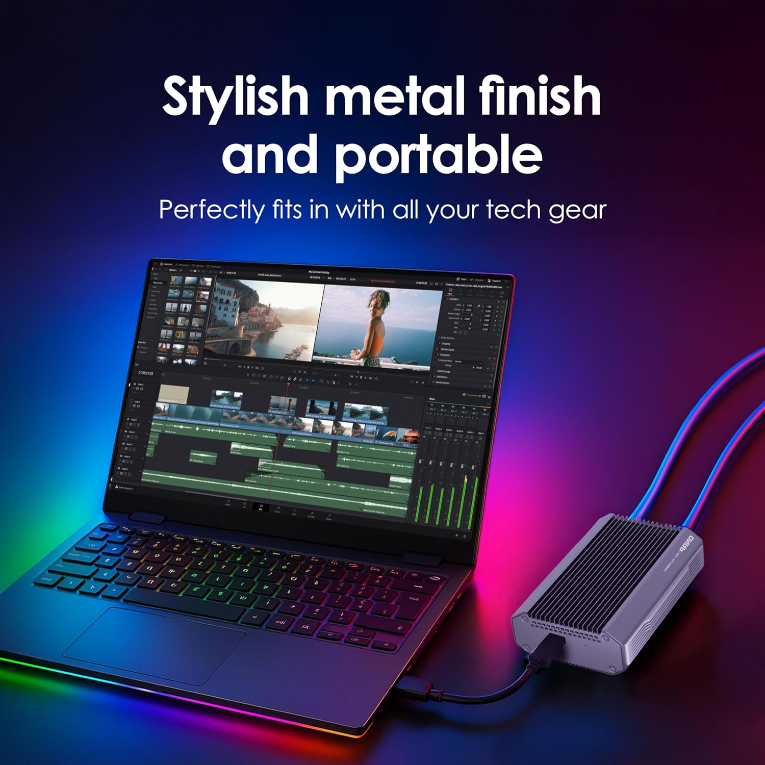 A silver portable power adapter with blue LED cable lighting shown next to an open laptop on a dark surface with colorful neon reflections. White text at the top reads 'Stylish metal finish and portable' and 'Perfectly fits in with all your tech gear'.