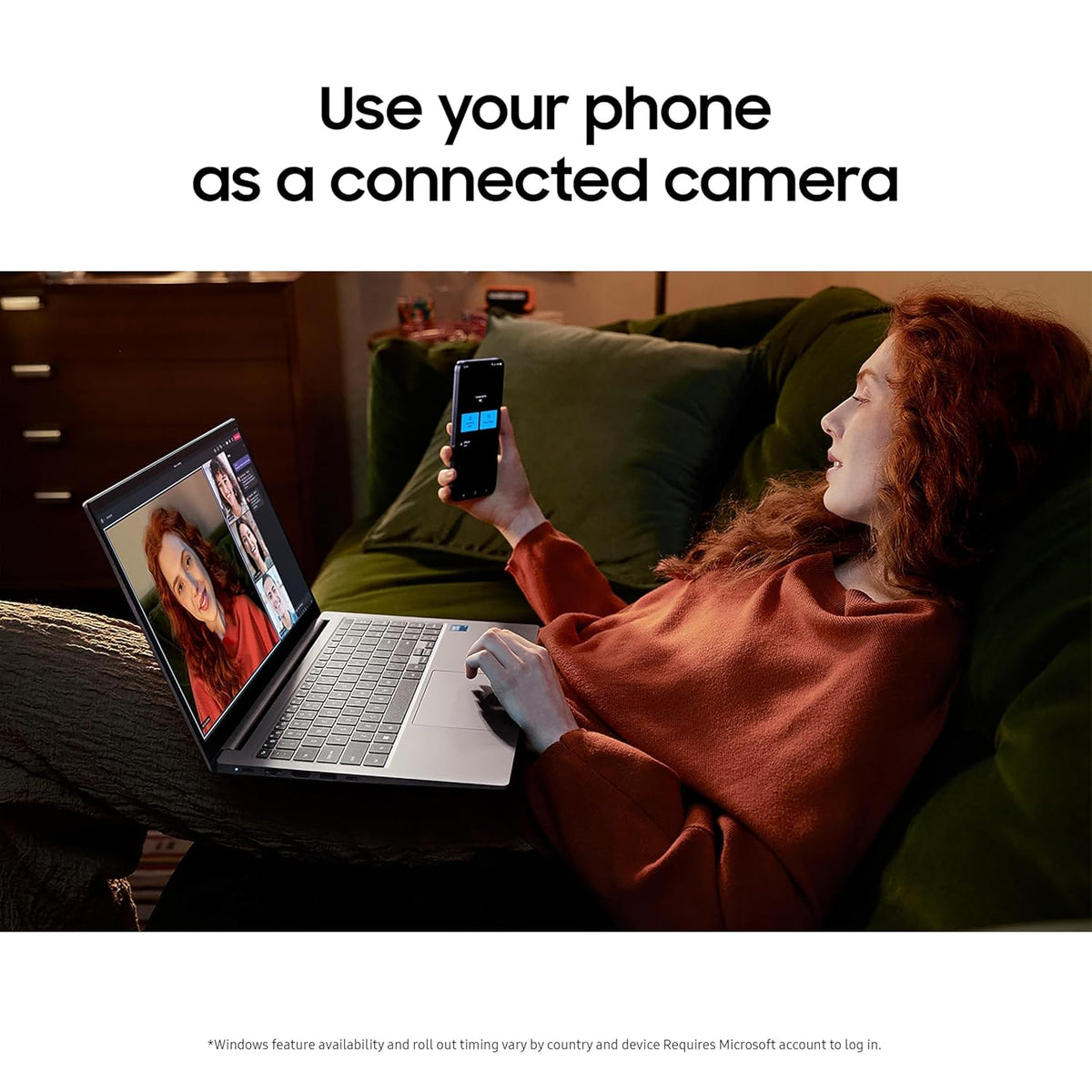 Person using a phone as a connected camera on a laptop, sitting on a couch.