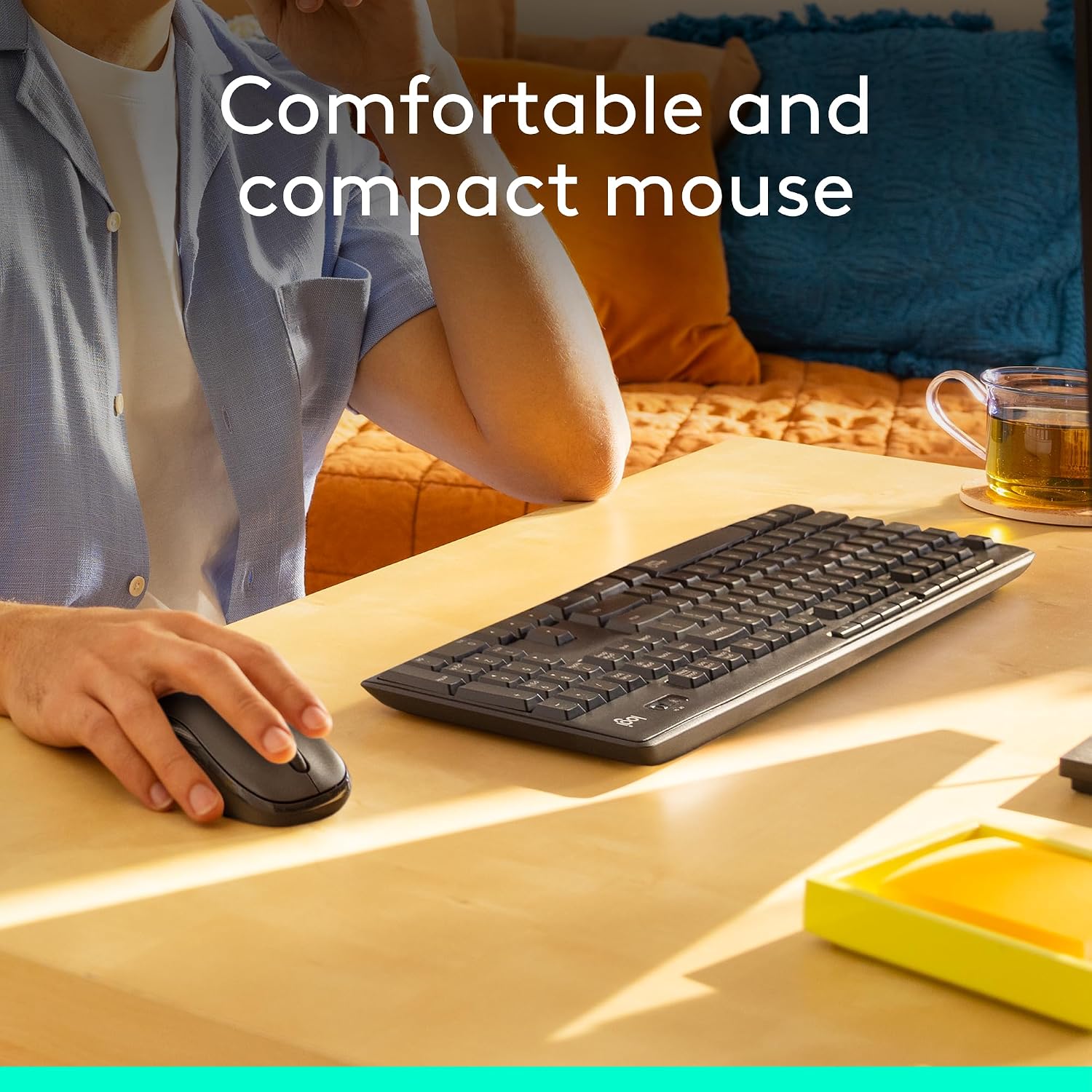 Person using a computer mouse and keyboard on a desk with text 'Comfortable and compact mouse'.