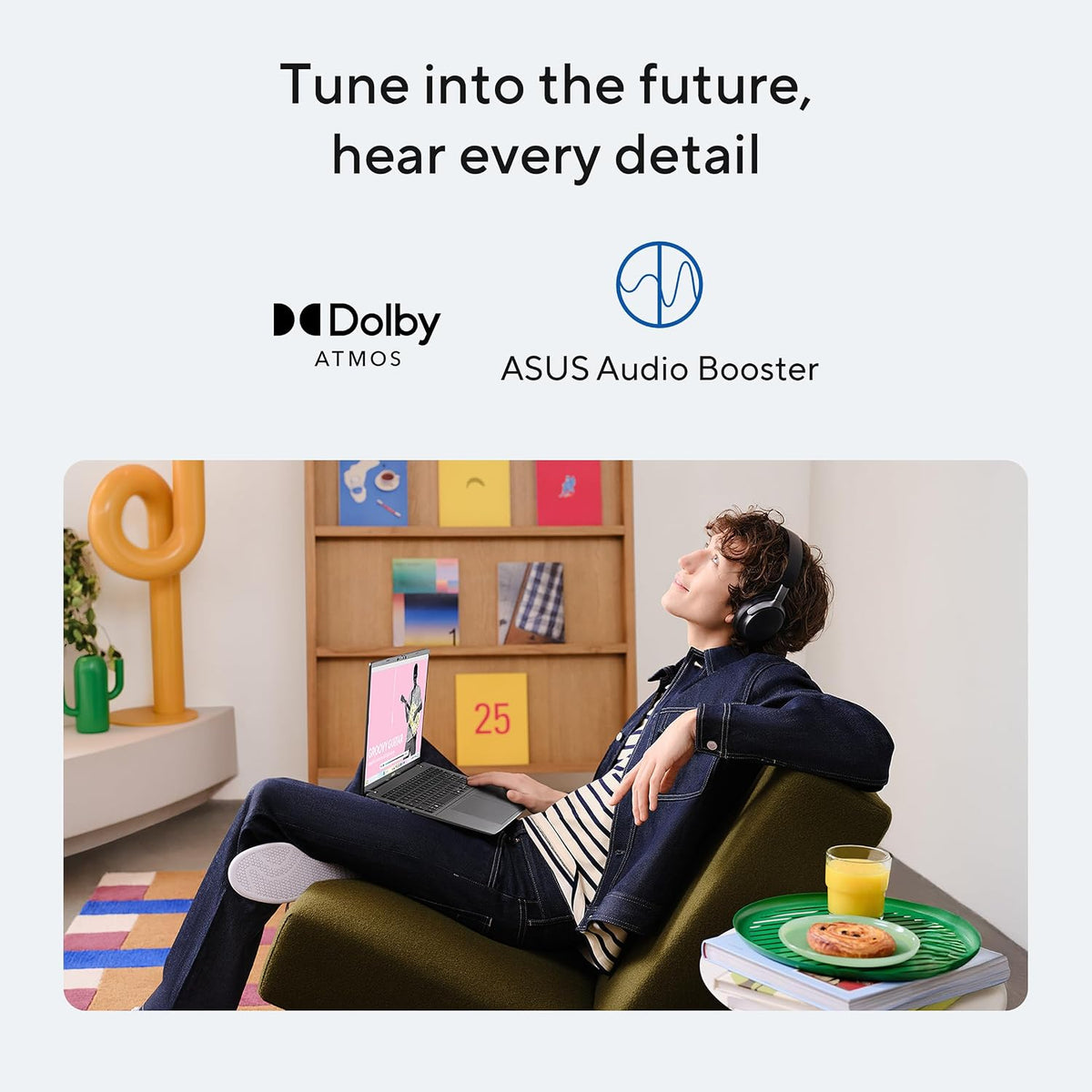Person sitting on a couch with a laptop, surrounded by ASUS Audio Booster and Dolby Atmos branding.