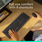 Person using a black keyboard and mouse on a desk with text 'Full size comfort with 8 shortcuts'.