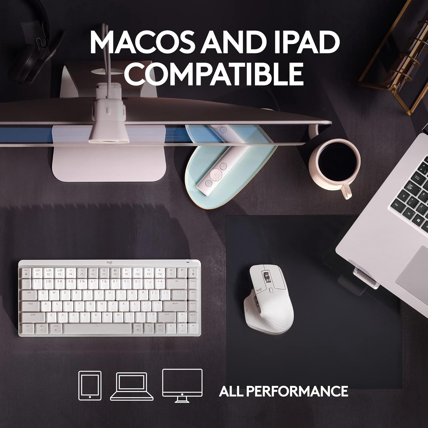 Desk setup with keyboard, mouse, and laptop on a dark surface, featuring text about Macos and iPad compatibility.