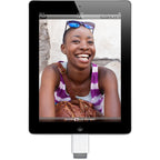 An iPad with a black front bezel and silver side edges, shown on a white background with a white dock connector attached below. The screen displays a photo of a smiling woman.