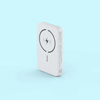 A white rectangular portable power bank with rounded corners, featuring a black wireless charging symbol on the front, set against a solid light blue background.