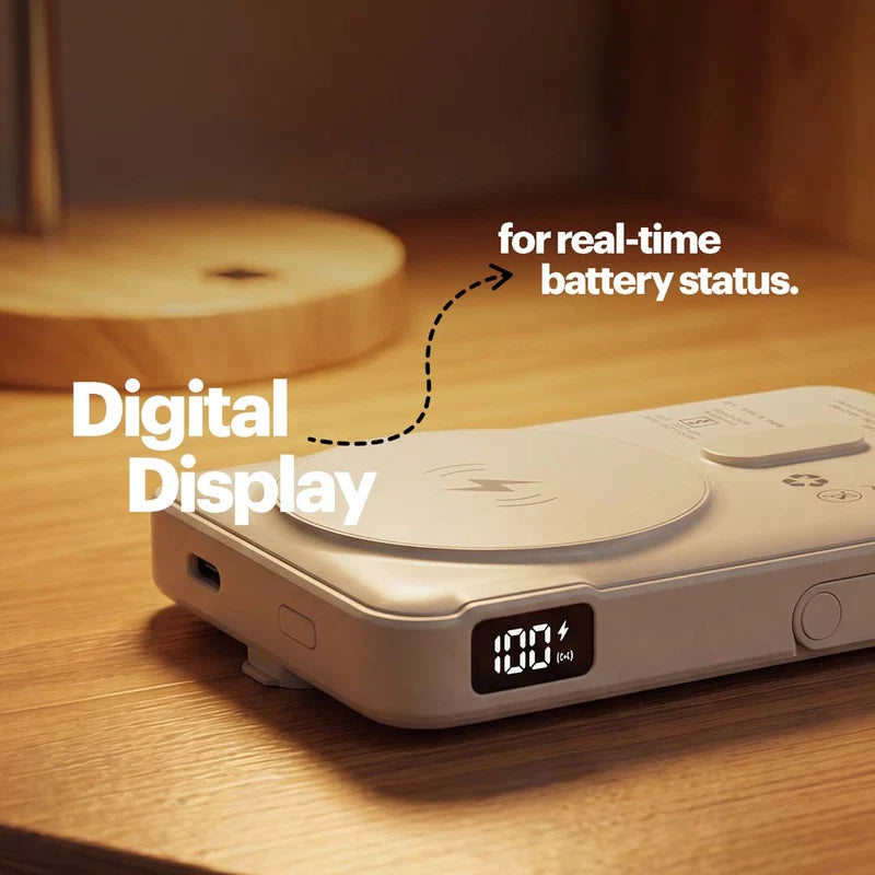 A portable power bank with a digital display showing 100% battery status, placed on a wooden table with text overlays highlighting its digital display feature.