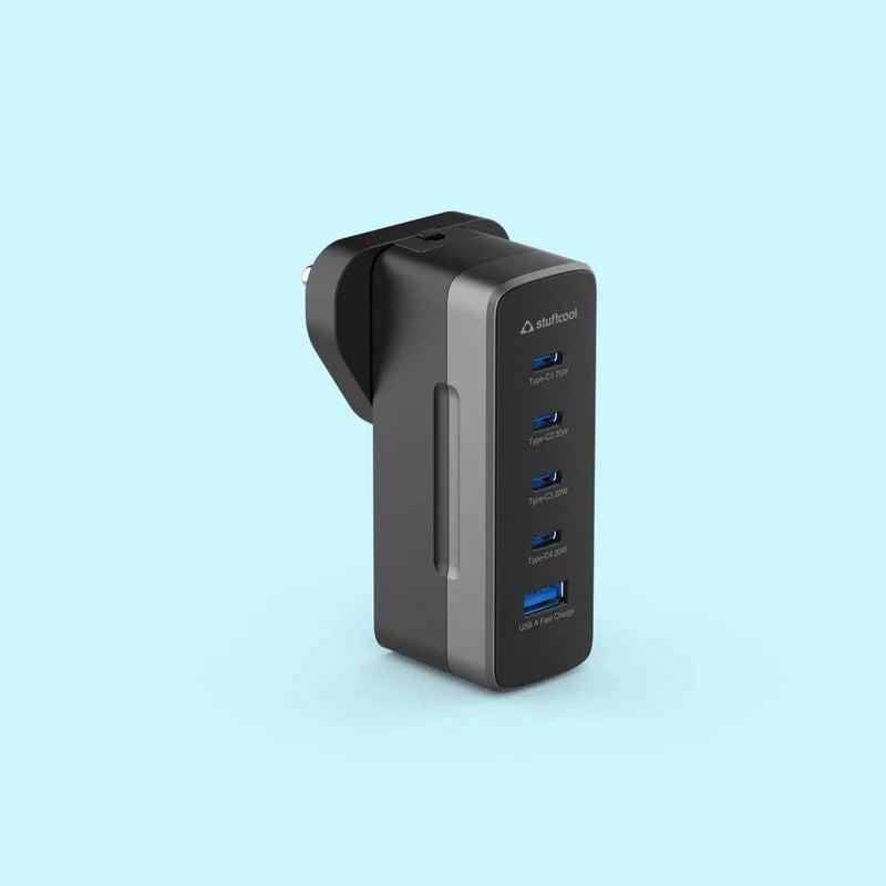 A black and dark gray 4-port USB-C charger by daFuCooz, shown from a three-quarter angle on a light blue background.