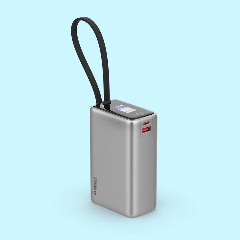 Silver power bank with a black strap on a light blue background