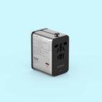 A 70W travel adapter by Airtool, featuring a dual-tone silver and black design, shown on a solid light blue background.