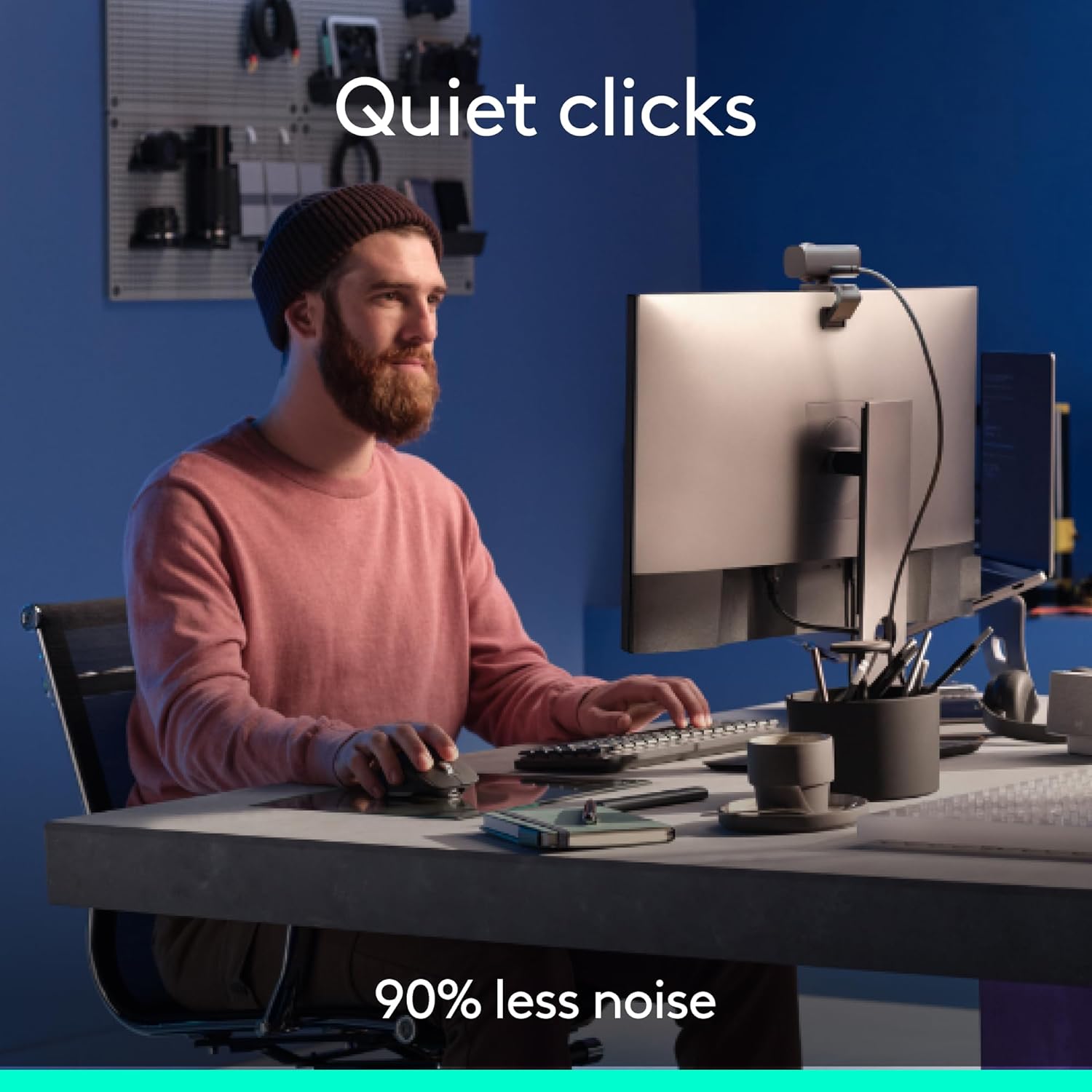 Person sitting at a desk with computer equipment, text 'Quiet clicks' and '90% less noise'.