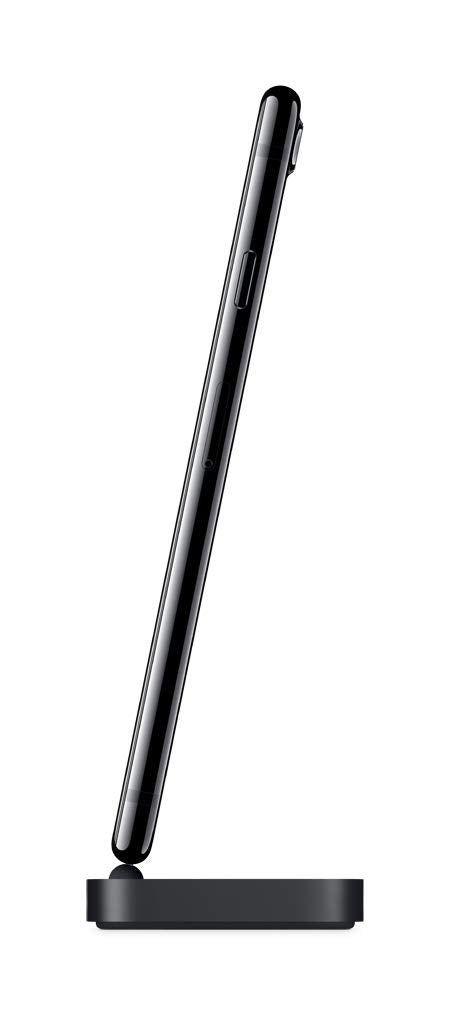 A black tablet shown from a side profile view, resting on a matching black charging dock against a plain white background.