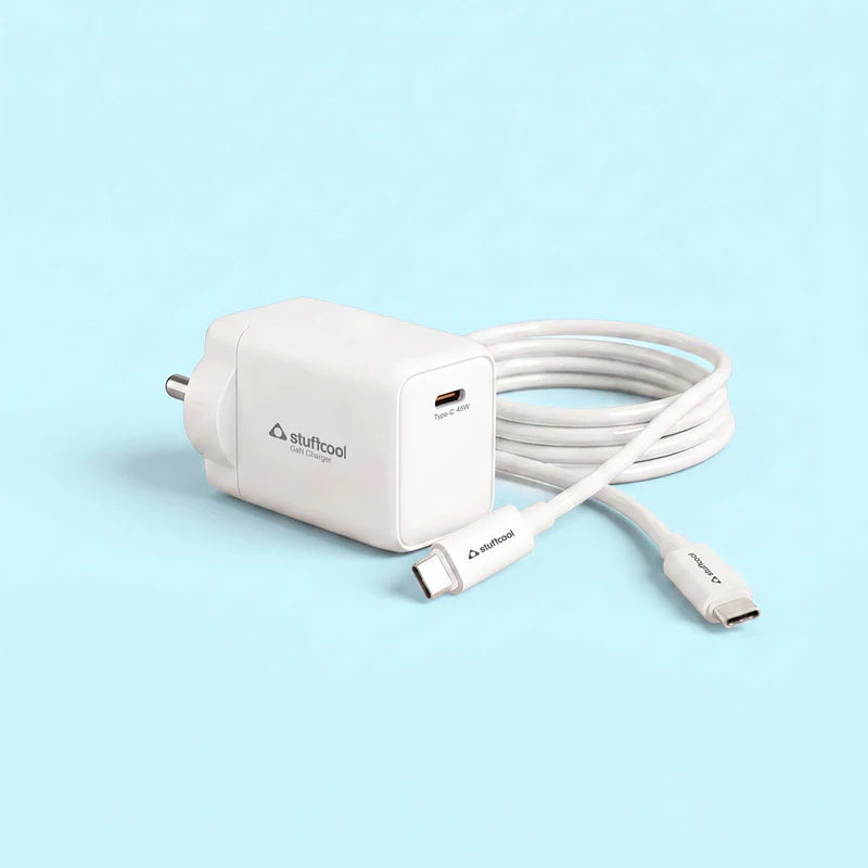 A white Stuftool USB-C fast charger with its matching USB-C cable coiled behind it, set against a solid light blue background.